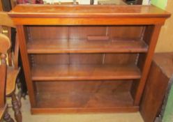 A 20th century oak bookcase with a rectangular top above two shelves on a plinth base