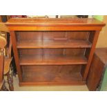 A 20th century oak bookcase with a rectangular top above two shelves on a plinth base