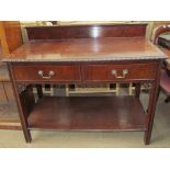 A Victorian mahogany side table with a raised back and a rectangular top with two drawers on square