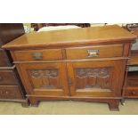 An Art Nouveau inspired sideboard with two drawers and two cupboards on square legs