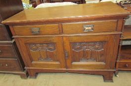 An Art Nouveau inspired sideboard with two drawers and two cupboards on square legs