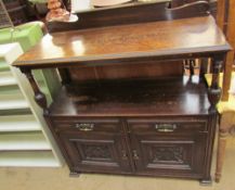 An early 20th century oak buffet with a raised back,