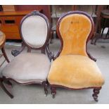A Victorian mahogany framed nursing chair together with another nursing chair
