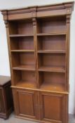 A pair of large 20th century bookcases with a moulded cornice, the one with a pair of glazed doors,