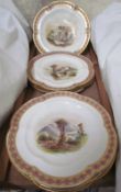 A 19th century dessert set painted with landscape scenes to a scalloped edge with pink,