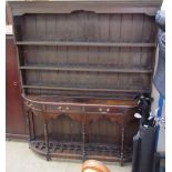 A Pine dresser, the rack with a moulded cornice and planked back,