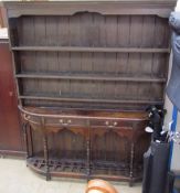 A Pine dresser, the rack with a moulded cornice and planked back,
