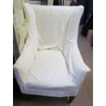 A 19th century upholstered elbow chair on tapering legs and casters
