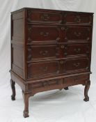 A 17th century style oak chest on stand, the oak planked top above two short,