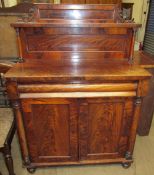 A Victorian mahogany chiffonier with a raised back and shelf, the base with a rectangular top,