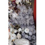 A large lot including brass candlesticks, glass decanters, drinking glasses, part tea sets,