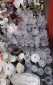 A large lot including brass candlesticks, glass decanters, drinking glasses, part tea sets,