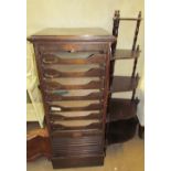 An oak filing cabinet with sliding drawers and a tambour front together with a corner whatnot