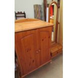 A pine side cabinet together with a pine coeval mirror