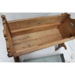 A Swiss pine cradle, with penwork decorated panels, on a later stand and inset zinc planter,