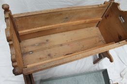 A Swiss pine cradle, with penwork decorated panels, on a later stand and inset zinc planter,