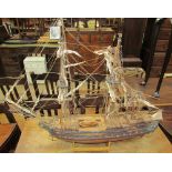 A model ship with three masts and rigging