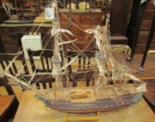 A model ship with three masts and rigging