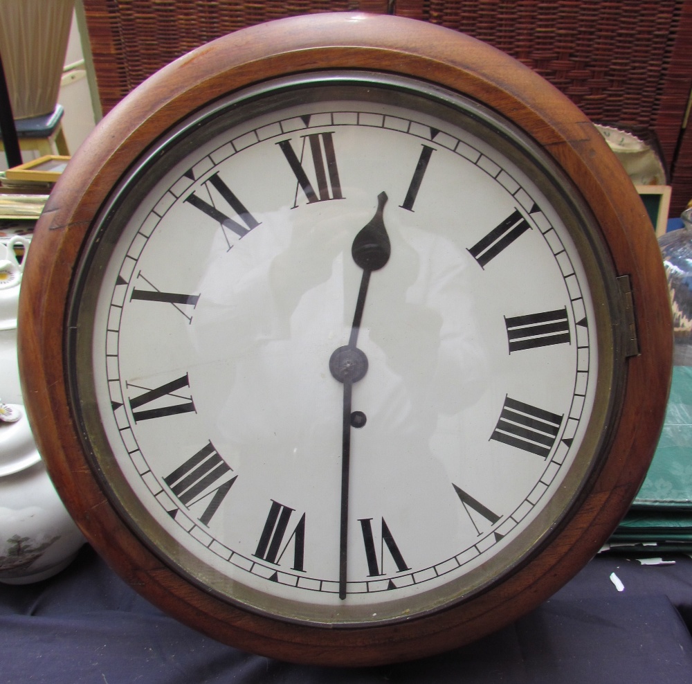 A railway type timepiece with a circular dial with Roman numerals