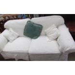 A cream upholstered two seater settee