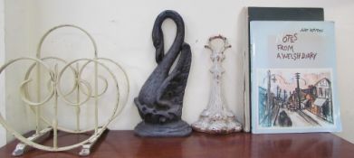 A cast iron swan doorstop together with another cast iron door stop, a magazine rack,