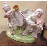 A continental porcelain planter with two clown playing musical instruments