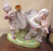 A continental porcelain planter with two clown playing musical instruments