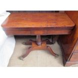 An early Victorian mahogany card table with a rectangular top on a turned column and four legs with