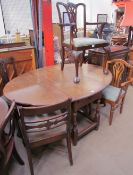 A 20th century oak gateleg dining table together with a set of three George III style mahogany