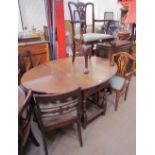 A 20th century oak gateleg dining table together with a set of three George III style mahogany