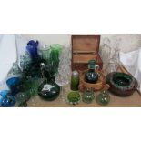 A green glass ewer together with glass decanters, green glass drinking glasses,