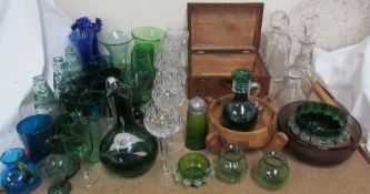 A green glass ewer together with glass decanters, green glass drinking glasses,