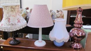 A copper lustre table lamp together with three other table lamps