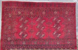 A red ground Turkoman rug with multiple guard stripes,