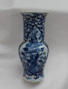 A garniture of three Chinese porcelain vases, the central vase with a flared rim and baluster body,