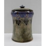 A Royal Doulton stoneware jar and cover, decorated with purple flowerheads to a blue band,