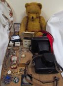 A mohair teddy bear together with two cameras, watches,