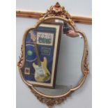 A gilt framed wall mirror together with an oak oval wall mirror