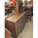 A 20th century oak dining room suite comprising an extending dining table, six assorted chairs,