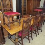 A 20th century oak refectory table with a planked rectangular top on turned baluster legs together