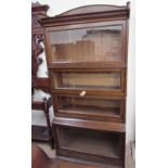 A Lebus oak sectional bookcase with a moulded cornice above four glass doors together with another