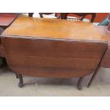 A 20th century oak gate leg dining table with drop flaps on cabriole legs and pad feet