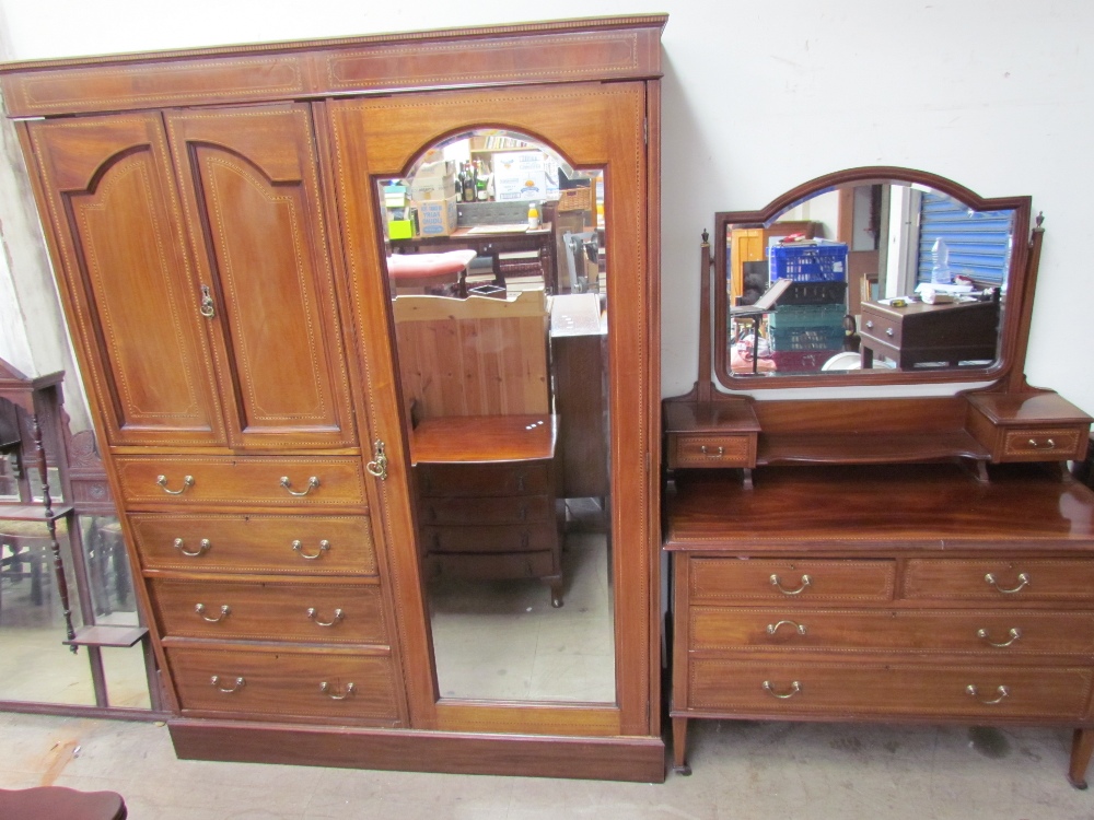 An Edwardian mahogany wardrobe with a mirrored door,