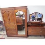 An Edwardian mahogany wardrobe with a mirrored door,