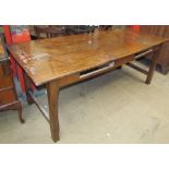 A Cherry wood refectory table with a planked rectangular top on shades square legs