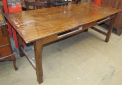 A Cherry wood refectory table with a planked rectangular top on shades square legs