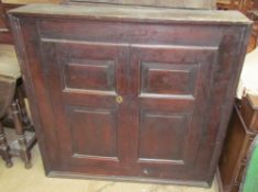 An 18th century oak side cabinet with a pair of panelled doors together with a small oak wall