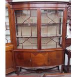 An Edwardian mahogany display cabinet, the moulded cornice above a pair of astragal glazed doors,