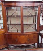 An Edwardian mahogany display cabinet, the moulded cornice above a pair of astragal glazed doors,