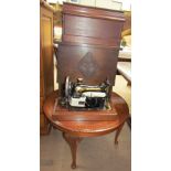 A Singer sewing machine together with an oak coffer with sewing materials and a coffee table